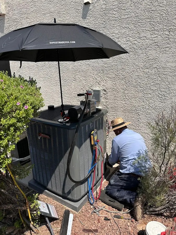 HVAC technician performing outdoor AC maintenance in Montgomery